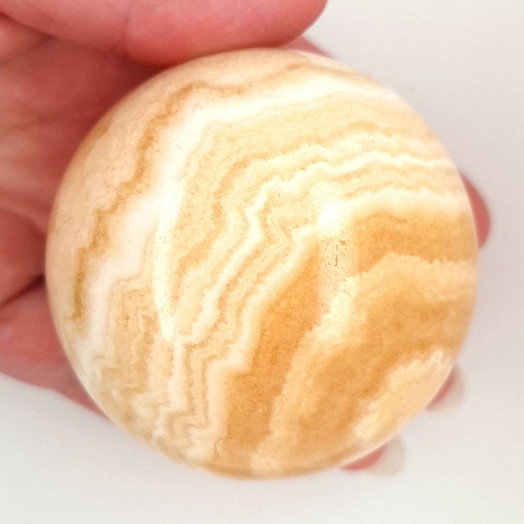 Radiant Orange Banded Calcite Sphere: A Gem of Natural Beauty