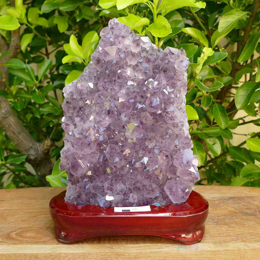amethyst cluster on wood display stand